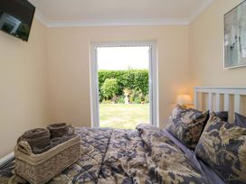 A bedroom with a bed and towels in a basket at No 8 in Burnham-on-Sea