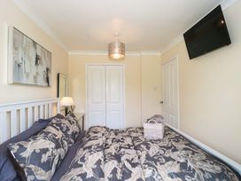 A bedroom with a bed and TV at No 8 in Burnham-on-Sea