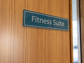 A fitness suite sign on a wooden door at Lodge 67 at Riviera Bay Coastal Retreat Brixham