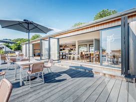 An outdoor seating area with tables and chairs at The Bay at Riviera Bay Coastal Retreat Brixham