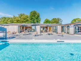 An outdoor seating area with a pool at Lodge 67 at Riviera Bay Coastal Retreat Brixham