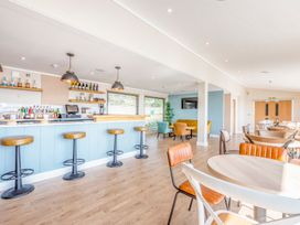 A lounge area with a bar and seating at Lodge 67 at Riviera Bay Coastal Retreat Brixham