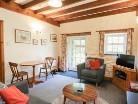 A living room with a table and chairs at Royal Oak Farm Cottage Betws-y-Coed