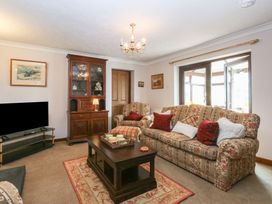 A living room with furniture and a television at Tir Mawr in Llanfairpwllgwyngyll
