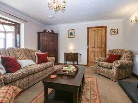 A living room with two sofas and a coffee table at Tir Mawr in Llanfairpwllgwyngyll