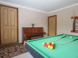 A snug with a pool table and a piano at Tir Mawr in Llanfairpwllgwyngyll