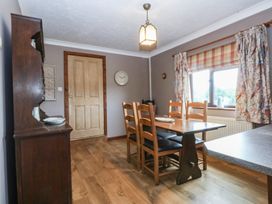 A dining room with a table and chairs at Tir Mawr in Llanfairpwllgwyngyll