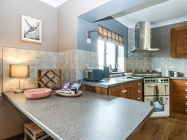 A kitchen with a sink and oven at Tir Mawr in Llanfairpwllgwyngyll