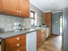 A kitchen with a sink and appliances at Tir Mawr in Llanfairpwllgwyngyll