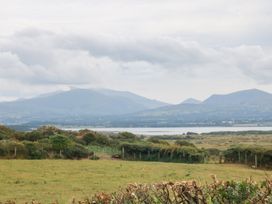 A landscape view with mountains and water at Tir Mawr in Llanfairpwllgwyngyll