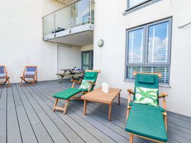 A deck with sun loungers and a table at 4 Ocean Gate Newquay