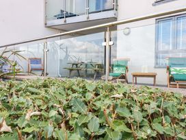 A balcony with chairs and a table at 4 Ocean Gate in Newquay