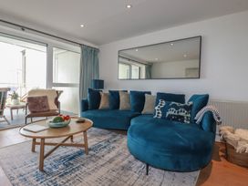 A living room with a sofa and coffee table at 4 Ocean Gate in Newquay