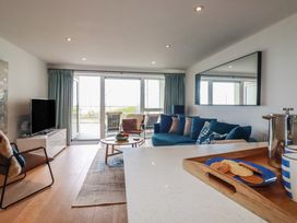 A living room with a sofa and television at 4 Ocean Gate in Newquay