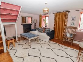 A living room with a sofa and coffee table at Pencestyll in Cardigan