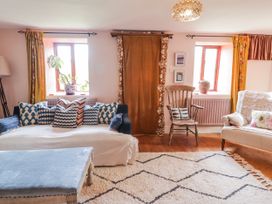 A living room with a sofa and chair at Pencestyll in Cardigan