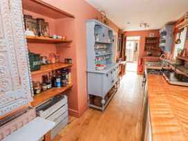 A kitchen with shelves and a cabinet at Pencestyll in Cardigan