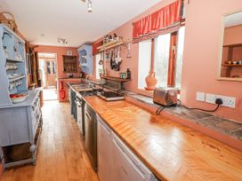 A kitchen with a stove and sink at Pencestyll in Cardigan
