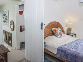 A bedroom with a bed and decorative elements at Pencestyll in Cardigan