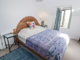 A bedroom with a bed and bedside table at Pencestyll in Cardigan