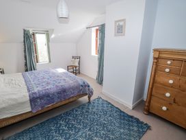 A bedroom with a bed and dresser at Pencestyll in Cardigan