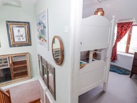 A hallway with a staircase and a bunk bed at Pencestyll in Cardigan