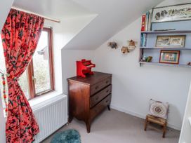 A bedroom with a chest of drawers and a window at Pencestyll Cardigan