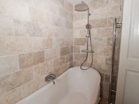 A bathroom with a bathtub and shower at Pencestyll in Cardigan