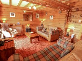 A living room with a sofa and armchair at Thistle Dubh (