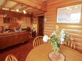 A dining room with a table and chairs at Thistle Dubh ('Doo') Sandyhills