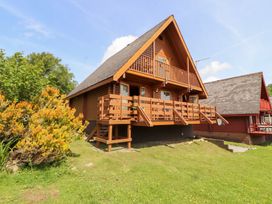 A wooden house with balconies and a garden at Thistle Dubh (