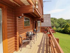 A balcony with a table and chairs at Thistle Dubh ('Doo') Sandyhills