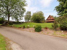 A house surrounded by grass and trees at Thistle Dubh ('Doo') Sandyhills