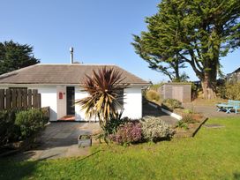 An outdoor view of a house with plants and patio furniture at 6 Trelawney Court in Rock
