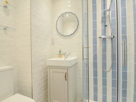 A bathroom with a sink and shower at 6 Trelawney Court in Rock