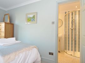 A bedroom with a dresser and shower at 6 Trelawney Court in Rock