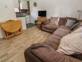 A living room with a sofa and TV at Tolroy Manor Holiday Park St Erth Praze near Hayle