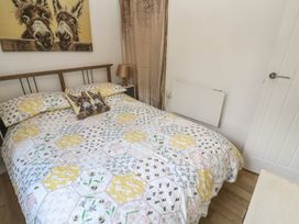 A bedroom with a bed and wall art at Tolroy Manor Holiday Park St Erth Praze near Hayle