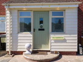 An entrance with a green door and sign at The Farmhouse in St. Osyth