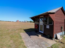 A bicycle store with a door and windows at The Farmhouse in St. Osyth