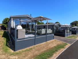 A holiday home with decking and outdoor furniture at Lakewood Plot 2 St. Osyth
