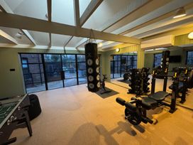 A gym with exercise equipment and a foosball table at Oak Cottage in Somerleyton
