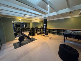 A gym with exercise equipment and a foosball table at Oak Cottage Somerleyton