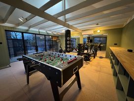 A game room with a foosball table and workout equipment at Oak Cottage Somerleyton