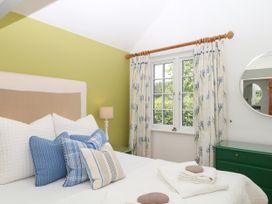 A bedroom with a bed and pillows at Apple Mill Venn Ottery near Sidmouth