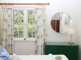 A bedroom with a window and dresser at Apple Mill Venn Ottery near Sidmouth