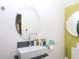 A bathroom with a sink and mirrors at Apple Mill in Venn Ottery near Sidmouth