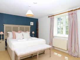 A bedroom with a bed and a window at Apple Mill Venn Ottery near Sidmouth