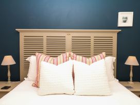 A bedroom with a bed and lamps at Apple Mill in Venn Ottery near Sidmouth