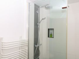 A shower area with glass enclosure and towel rail at Apple Mill in Venn Ottery near Sidmouth